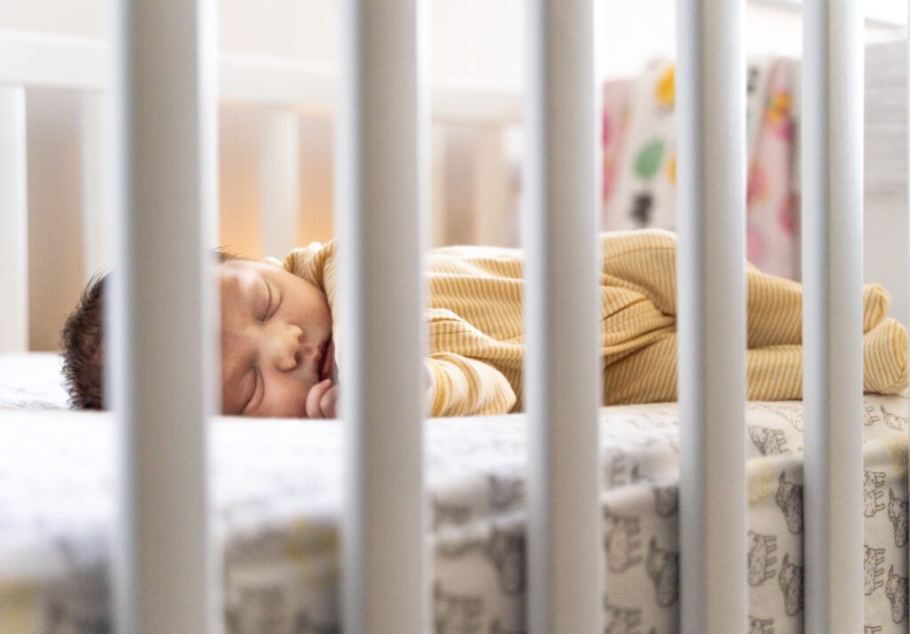 infant sleeping in crib