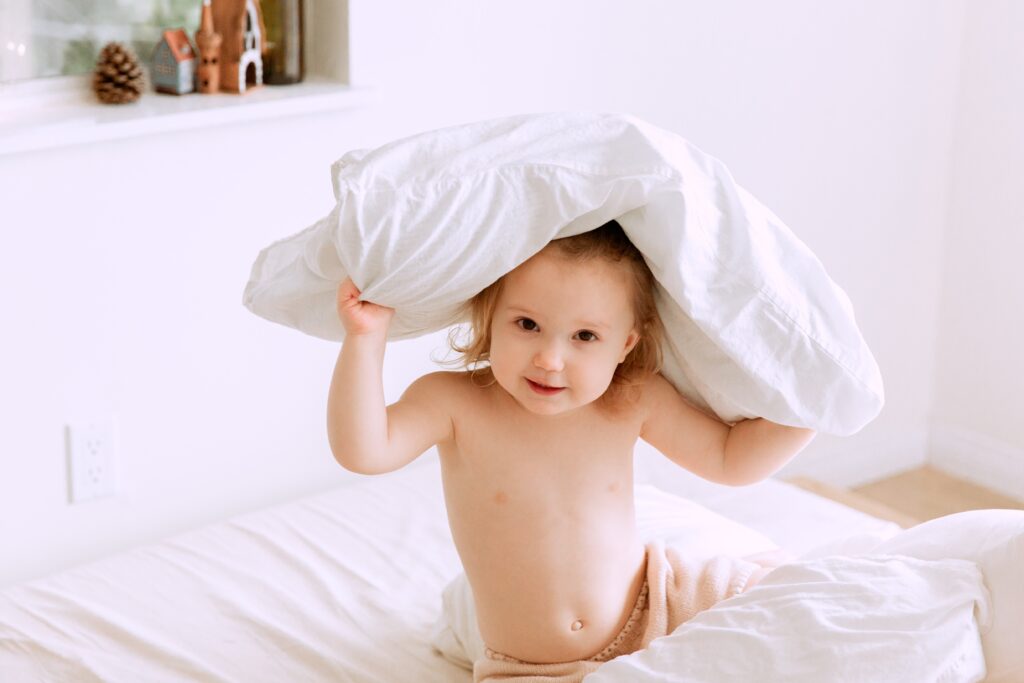 Child in bed with pillow