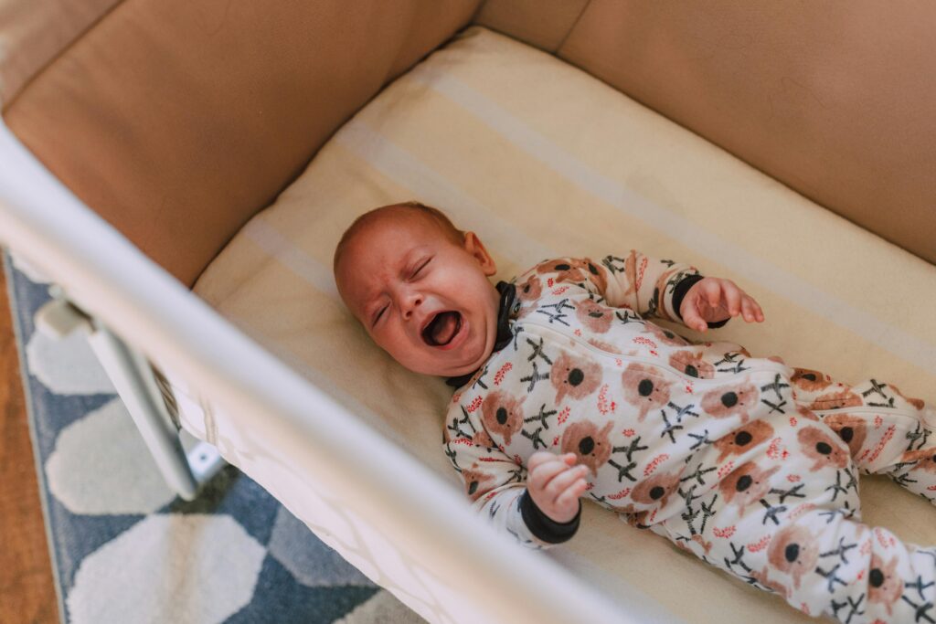 child crying in bassinet 